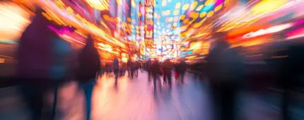 Blurred photo of a vibrant Las Vegas street at night, filled with colorful lights, neon signs, and crowds of people.